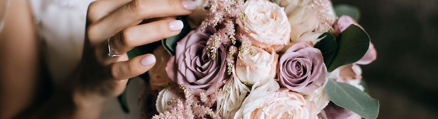 The bride holds a beautiful wedding bouquet of pink and white fl